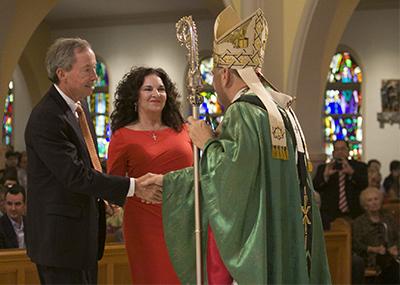 In this November 2012 file photo, Archbishop Thomas Wenski gives the One in Hope award to Keith and Doreen Koenig of St. Gregory Parish in Plantation.