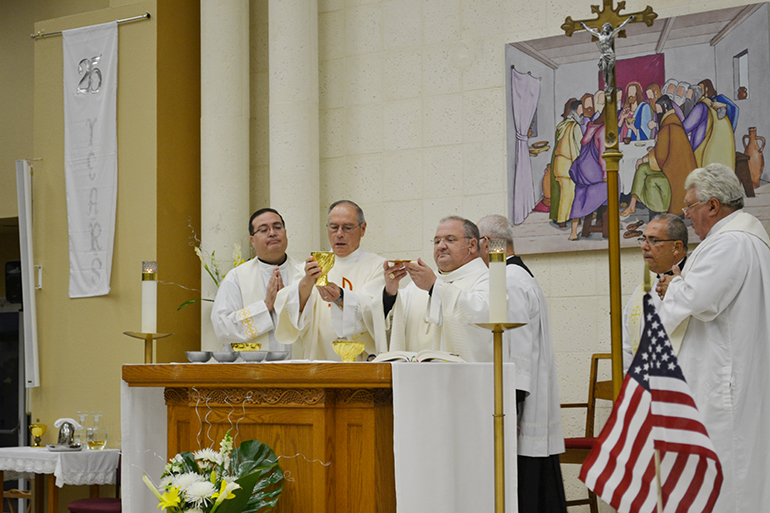 Auxiliary Bishop of Miami, Peter Baldacchino (center) celebrated the 25 year anniversary Mass of St. Martin de Porres, in Leisure City. He celebrated the Mass with, from left to right, Father Carlos Vega (administrator of the parish from 2001-2010); Deacon Santos Rodriguez; Father Joaquin Rodriguez, the current pastor as of 2010; and Father Luis Rivera, the founding pastor who served from 1990-1996.