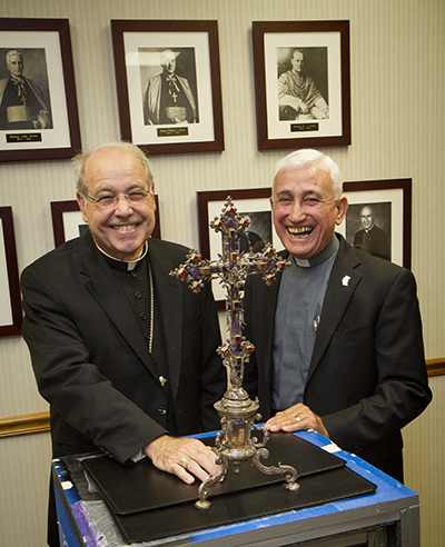 St. Augustine Bishop Felipe Estevez, left, and Father Sal Di Fazio, pose with the relic of St. Augustine of Hippo after it arrived at the diocesan offices June 25.