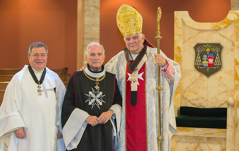Msgr. Tomas Marin, an Order of Malta chaplain, left, poses with Fernando Garcia Chacon, president of the Cuban Association, and Archbishop Thomas Wenski. Both are wearing their newly awarded Cross Meritis Melitense for "pious deeds."