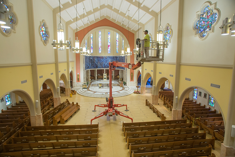 Looking like a spider, the Teupen Leo series aerial lift occupies the floor of St. Mary Cathedral. The front pews on the main aisle were removed to extend the machine's multi-position stabilizing legs.