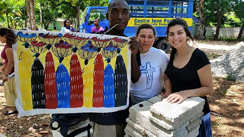 A local artist shows off his work depicting every day life in Haiti.