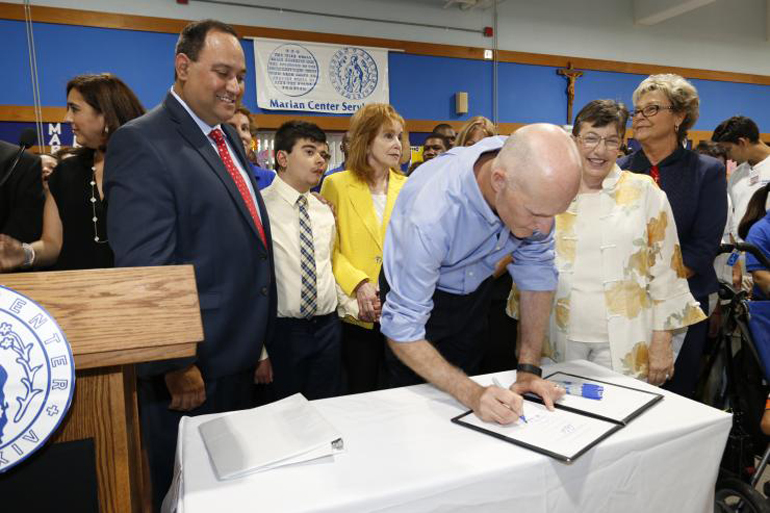 Gov. Rick Scott symbolically signs into law the ABLE Act (Achieving a Better Life Experience), which creates a trust fund to help disabled children and adults obtain services such as therapy and job training. Looking on are state Rep. Ray Rodrigues, left, of Fort Myers, state Sen. Eleanor Sobel of Miami-Dade and Broward counties, center, and Barbara Palmer, far right, director of the state Agency for Persons with Disabilities.