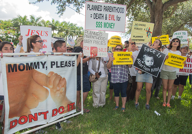Hundreds of people protested against Planned Parenthood outside one of their clinics in Kendall, Saturday, Aug. 22, as part of nationwide revulsion to undercover videos put out by Center for Medical Progress. The videos show Planned Parenthood officials describing the harvesting of fetal tissues from aborted babies and discussing charges for the tissues.