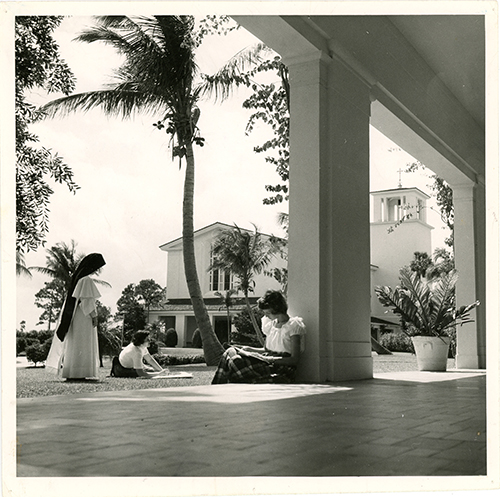 Barry University back then: Students study outside Adrian Hall as an Adrian Dominican sister stands by in this historical photo.