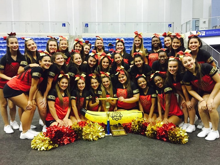 The Msgr. Pace High Spartan Cheerleaders pose with the First Place, Leadership, and Overall Spirit awards they won at the UCA Camp Championship held at Nova Southeastern University July 22 through 25.