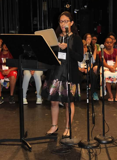 Ashley Zelaya steps up to the microphone as she competes at the National Spanish Spelling Bee in Albuquerque, New Mexico. Ashley, a graduate of Sts. Peter and Paul School, represented Miami and placed third in the competition.