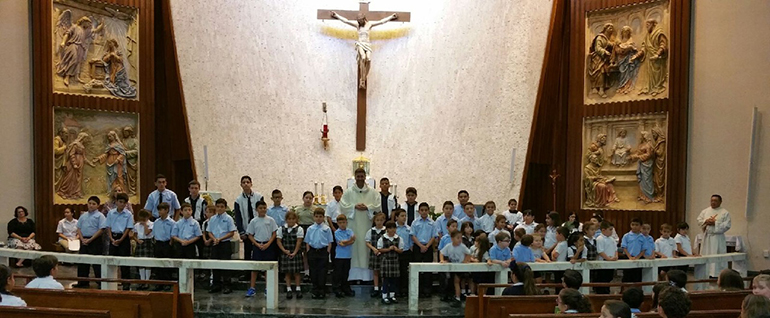 Father Manny Alvarez, pastor, welcomed 59 new students to Immaculate Conception School this year. He posed with the new Celtics after celebrating the first Mass of the school year with the entire student body.