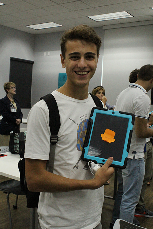 Gabriele LaFata shows off the iPad he will be using during his cultural exchange visit at McCarthy High School.
