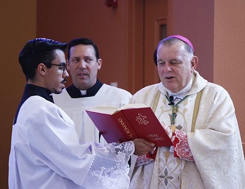 Archbishop Thomas Wenski celebrates Mass before blessing the Latino Americans: 500 Years of History exhibit at the Archbishop John C. Favalora Archive and Museum inside the St. Thomas University Library Sept. 8, 2015.