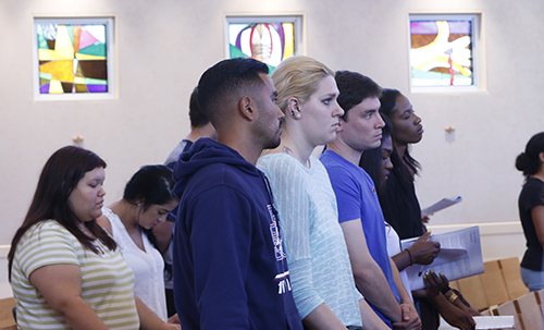 St. Thomas University students pray during the Mass in St. Anthony Chapel.