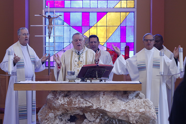 Archbishop Thomas Wenski celebrates Mass in the Chapel of St. Anthony before blessing the Latino Americans: 500 Years of History exhibit at St. Thomas University. Among the concelebrants were Msgr. Terence Hogan, left, dean of the School of Theology and Ministry, and Msgr. Franklyn Casale, right, president of the university.