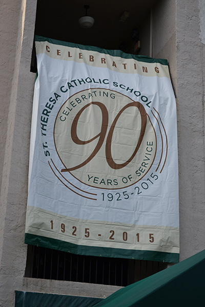 This 90th anniversary banner hangs from the third floor of St. Theresa School's building.