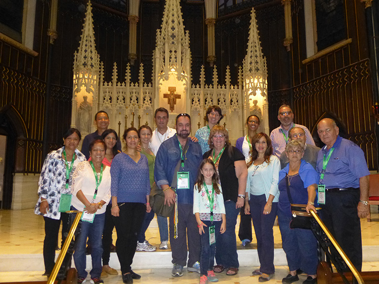The official 16-member pilgrimage group to the weekend festivities at the World Meeting of Families pose for a photo at St. John the Evangelist Church in Philadelphia before the celebration of a Mass for all the pilgrims by Archbishop Thomas Wenski.