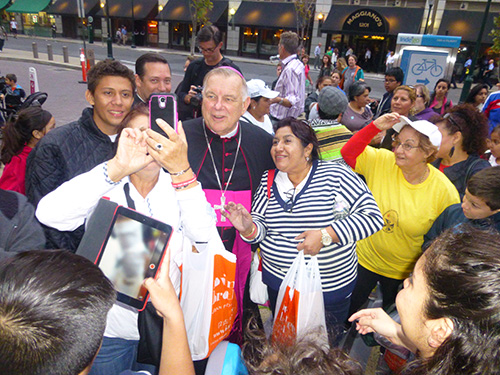 Parishioners from St. John Bosco, Our Lady of Divine Providence, San Lazaro and St. Dominic and other South Florida churches spot Archbishop Thomas Wenski shortly after he celebrated Mass in Philadelphia, and happily greeted him with songs and selfies.