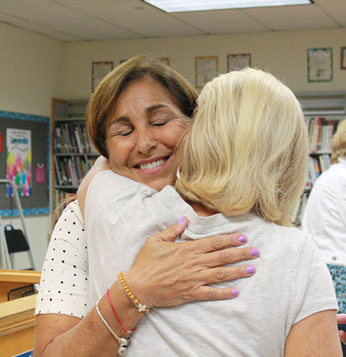 Ana Duran, St. Patrick Church Divorce Care facilitator, embraces a participant at the end of a group meeting.