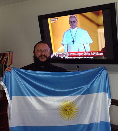 Father Jes&uacute;s Alberto Boh&oacute;rquez, administrator, St. Ann Mission with Argentina flag when Cardinal Jorge Mario Bergoglio was elected Pope and adopted the name of Pope Francis. Father Boh&oacute;rquez will accompany his parishioners on the pilgrimage to Philadelphia, with a return stop to see the historic sites in Washington, D.C.