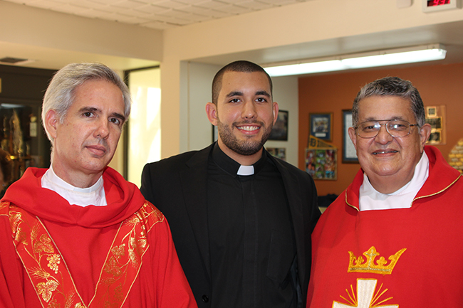 Belen Jesuit Preparatory School alumnus Michael Martinez made his first vows to the Society of Jesus (the Jesuits) at the schoolwide Mass Aug. 28. He is pictured with the main celebrant, Jesuit Father Javier Vidal, provincial of the Antilles Province, and Jesuit Father Pedro Suarez, Belen Jesuit School president.