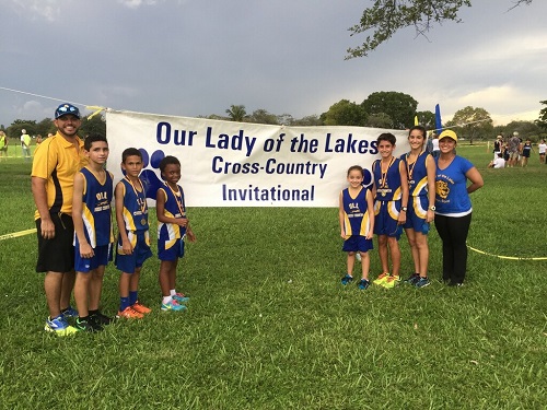 Our Lady of the Lakes cross country team pose for a photo, from left: Coach German Garcia, seventh grader David Espinosa (finished in seventh place), fourth grader Joshua Kunkel (finished in sixth place), fourth grader Daphney Lagoue (finished in eighth place), third grader Sayaniz Zaldivar (finished in 18th place), seventh grader Michael Sanchez (finished first place), seventh grader Danielle Martinez (finished in first place), and Coach Astrid Segredo. Not shown: fourth grader Sofia Mendez (finished 25th place)