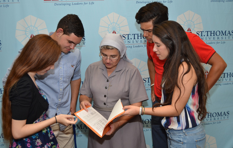 Sister Ondina Cortes of St. Thomas University discusses the academic year with incoming freshmen Sept. 9. From left are Alyssa Sanchez, Manuel Diaz, Sister Ondina, Paolo Ariano and Natasha Lopez.