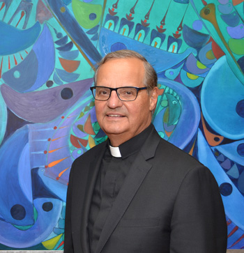 Msgr. Franklyn Casale, president of St. Thomas University, in his office. Behind him is a mural by a Cuban immigrant, donated to the university.