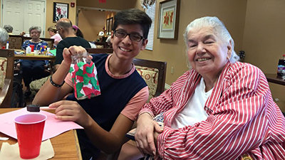 Youth 4 Christ member Adrian Mercado shares his time and talents by visiting the elderly and doing arts and crafts with them.