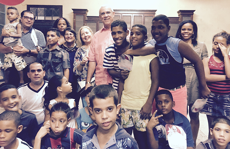 Sept. 19, 2015COURTESY PHOTOAndy Gomez, back center, and his wife, Frances Serantes Gomez, pose with some of the children and teenagers who benefited from his family's donations to La Merced parish in Havana. Parishioners threw a party for him and his in-laws, Virginia and Tony Rivas, far left, rear.