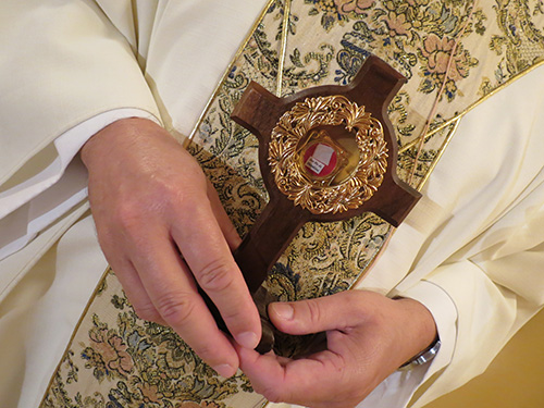 Father Luis Garcia, who has a special devotion for Padre Pio, holds the relic: a piece of cloth used to wipe the blood from Padre Pio’s wounds or stigmata.