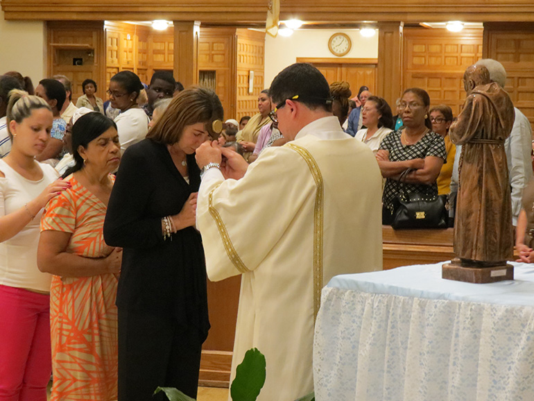 Deacon Raul Flores blesses parishioners with the relic of Padre Pio following the Mass at St. Mary Cathedral.