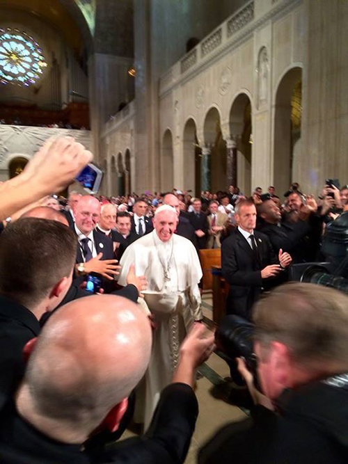 The view for the seminarians: Pope Francis walks by their pews inside the Basilica of the Immaculate Conception.