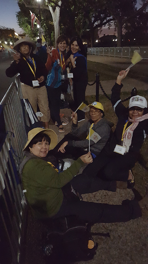 Waving Vatican flags and bundled for a brisk morning, Archdiocese of Miami pilgrims were among the first in line at the barricade fences that bordered the Ellipse in Washington D.C. It would be a few hours until Pope Francis passed by in his pope mobile.