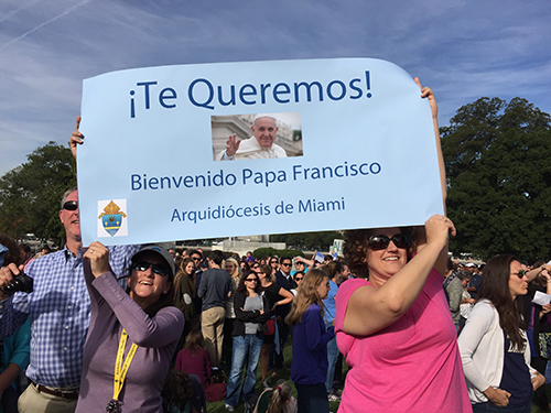 Miami pilgrims hold up their sign for Pope Francis before his appearance on the west lawn of the U.S. Capitol.