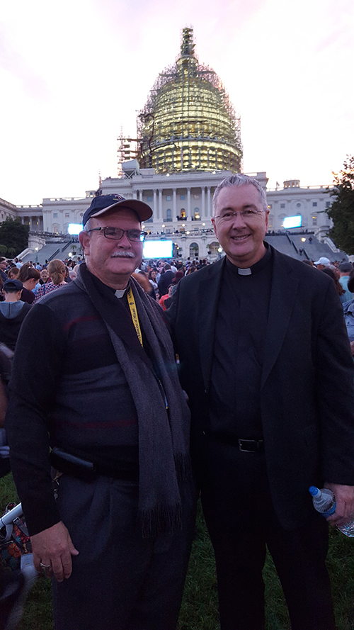 Msgr. Terence Hogan (right) was fortunate enough to find the pilgrims from the Archdiocese of Miami in the crowd behind the Capital building. Here, he poses with Bishop Fernando Isern (left) before the Capital building.