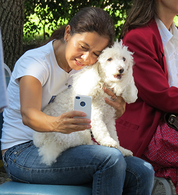 A pet owner takes a selfie before the start of the blessing outside of St. Martha's parish hall.