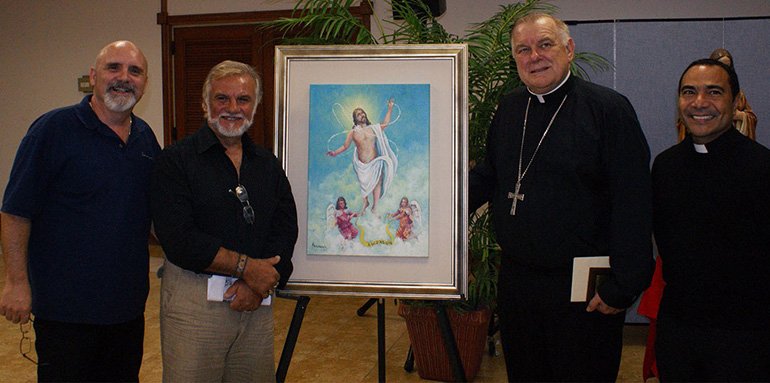 The men's Emmaus groups of St. Martha and St. Rose of Lima churches presented Archbishop Thomas Wenski with this painting as a gift. The image is one of 20 that will be featured in a book called "Pray the Rosary." Pictured here, from left: John Monteleon of St. Martha's men's Emmaus, artist Pietro Rapisarda, Archbishop Wenski and Father Wilfredo Contreras, St. Martha's pastor. The parishes' women's  Emmaus groups also presented the archbishop with a gift certificate to Harley Davidson.