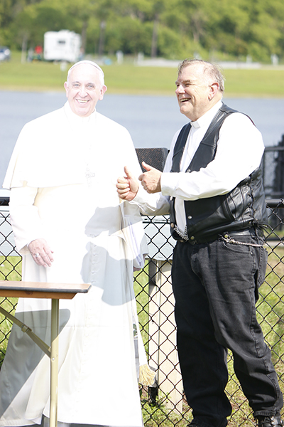 Thumbs up, Holy Father! Like many others that day, Archbishop Thomas Wenski poses with the cut-out of Pope Francis.