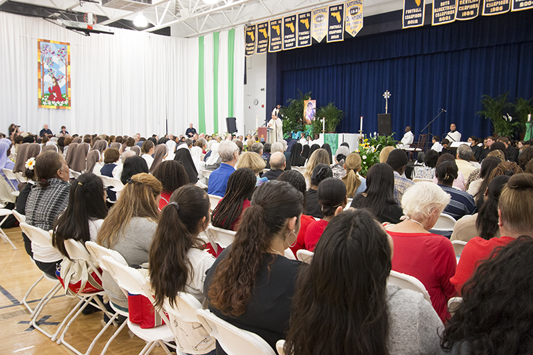 Nearly 1,000 catechists present for their annual conference listen to Archbishop Thomas Wenski as he celebrates the opening Mass.