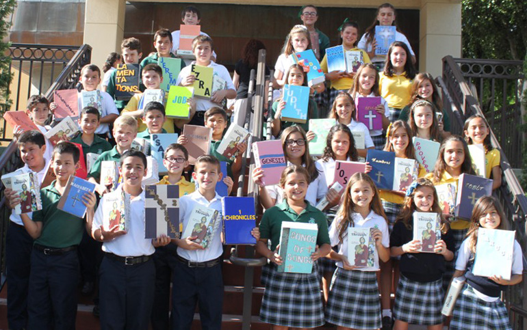 With different books from the Bible in hand, fifth grade students at St. Kevin School celebrated the Word of God at a special Mass, where their personal Bibles were also blessed.