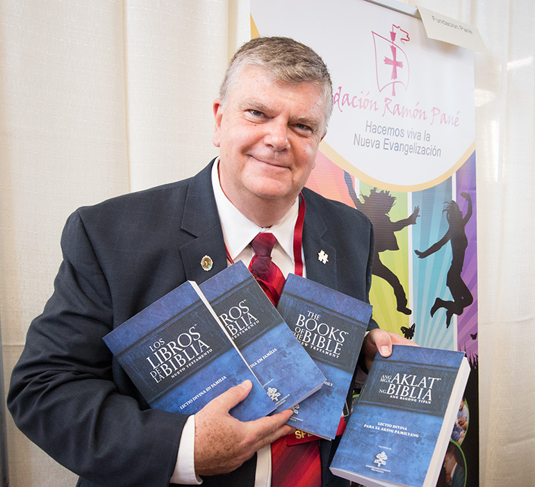 Ricardo Grzona, president and executive director of the Ramon Pane Foundation, holds up the Lectio Divina for Families books that were specifically requested by Pope Francis.