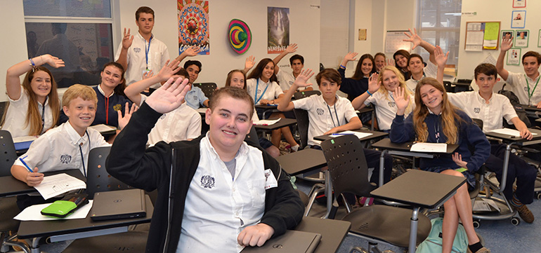 Parker Stevens waves along with schoolmates in Spanish class at St. Anthony School, Fort Lauderdale. He had recently returned from a visit with his favorite team, the Chicago Bulls. The October visit was made possible by the Make-A-Wish Foundation.