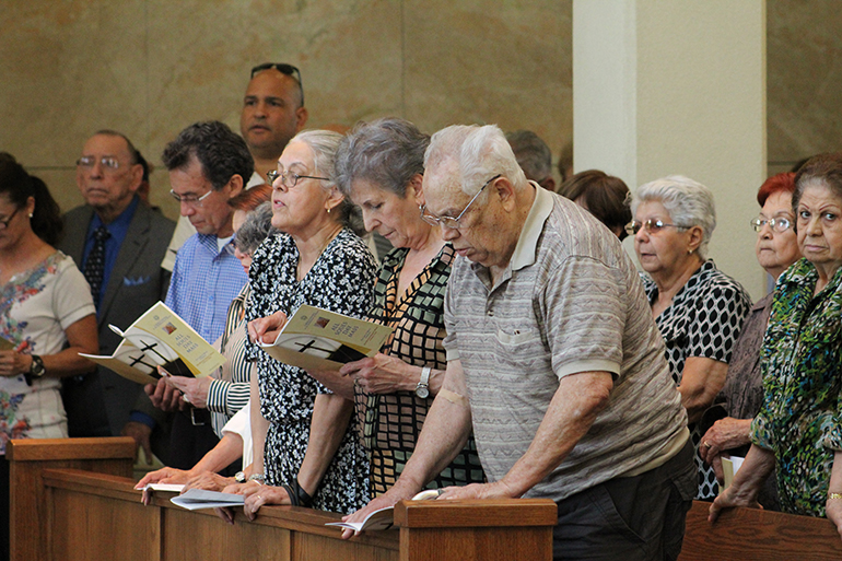 Remembering their dear departed, visitors seek comfort in the liturgy of the word during the All Souls Day Mass celebrated at the Ascension Mausoleum at Our Lady of Mercy Cemetery in Doral.