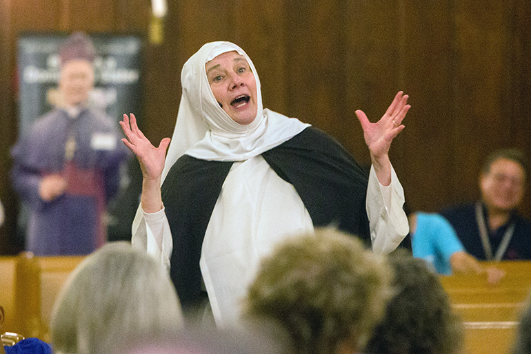 In character as St. Catherine of Siena, Dominican Sister Nancy Murray makes a joke after entering Barry University's Cor Gesu Chapel.