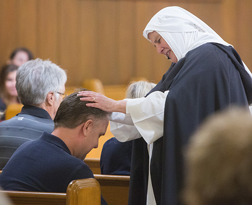 St. Catherine of Siena, as portrayed by Dominican Sister Nancy Murray, blesses an audience member during her performance at Cor Jesu Chapel.