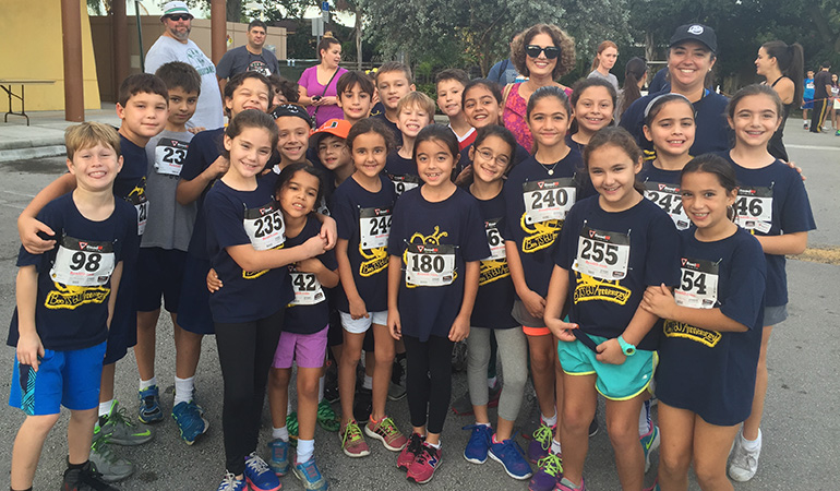 Berta Cabrera, second from right, in back, poses with Blessed Trinity's third graders before their Turkey Trot 5K run/walk.