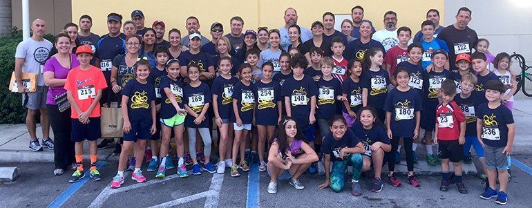 The third grade Turkey Trotters from Blessed Trinity School, along with their parents and teachers, pose for a picture before their 5K run/walk.