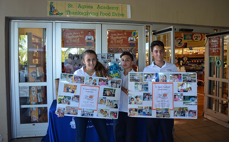 St. Agnes Academy students stand outside a local supermarket announcing their Thanksgiving goal of feeding 600 families.