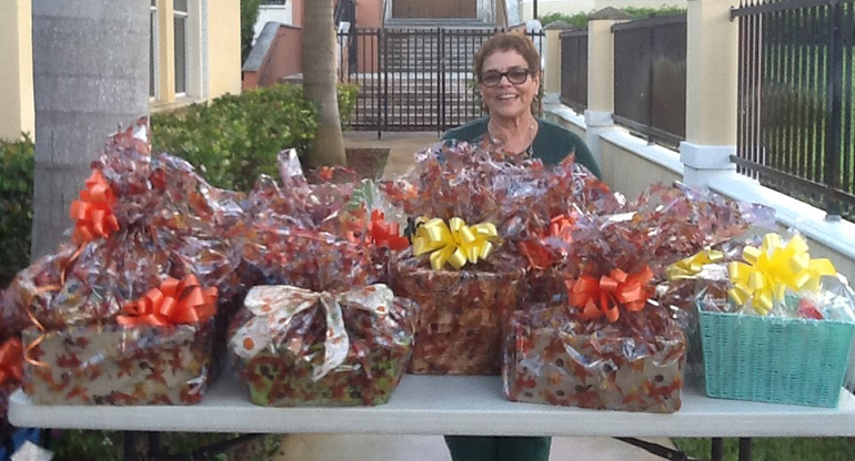 St. Michael School's principal, Carmen Alfonso, poses with some of the Thanksgiving gift baskets school children donated to needy families living around St. Mary Cathedral in Miami.