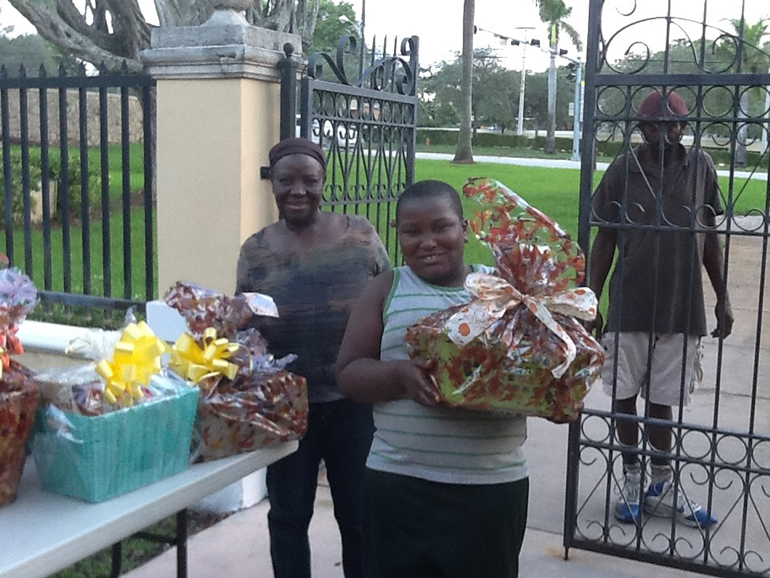 Families living around St. Mary Cathedral pick up Thanksgiving gift baskets prepared by students in St. Michael School's Mission Club.