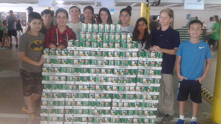 St. Anthony School students pose with some of the "bounty" they collected for the needy of Broward County this Thanksgiving.