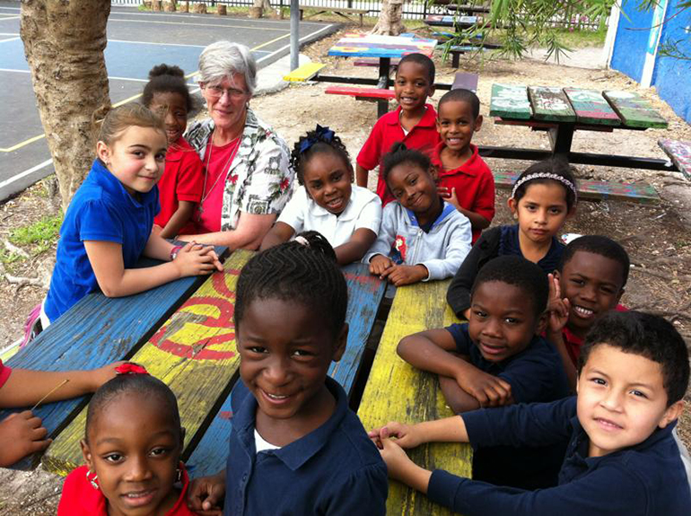 Sister Suzanne Lasseigne, a member of the Society of the Sacred Heart working in South Florida, poses with children she serves at the Barnyard Community Center in Coconut Grove.
